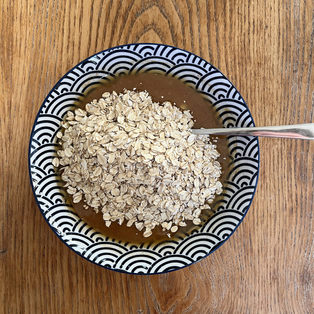 Add the oats to the banana oatmeal cookie batter