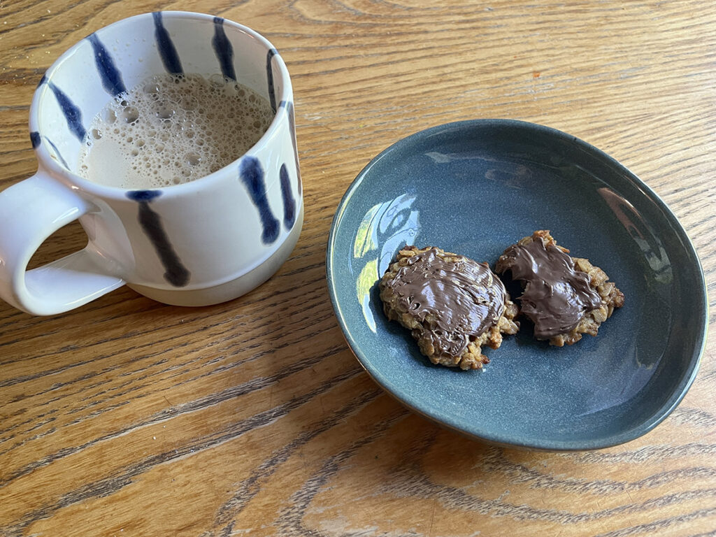 Chocolate topped banana oatmeal cookies with hot coffee