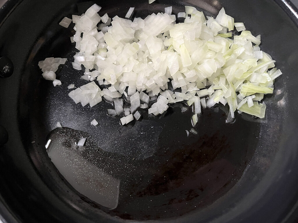 Start by adding onion to olive oil to make the olive-free pasta puttanesca sauce