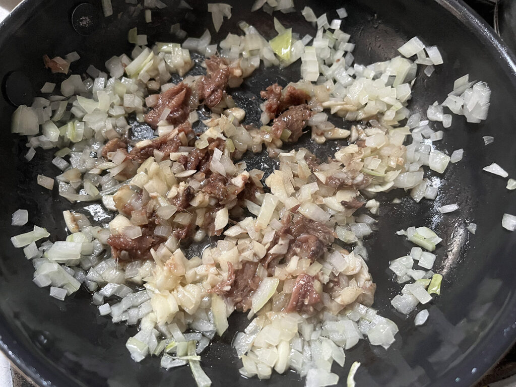 Followed by the garlic for the olive-free pasta puttanesca sauce