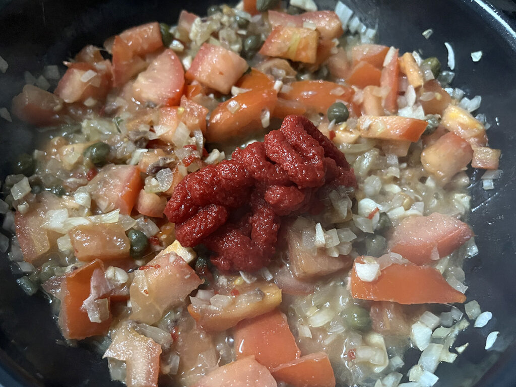 The tomato pasta adds depth to the tangy olive free puttanesca pasta sauce